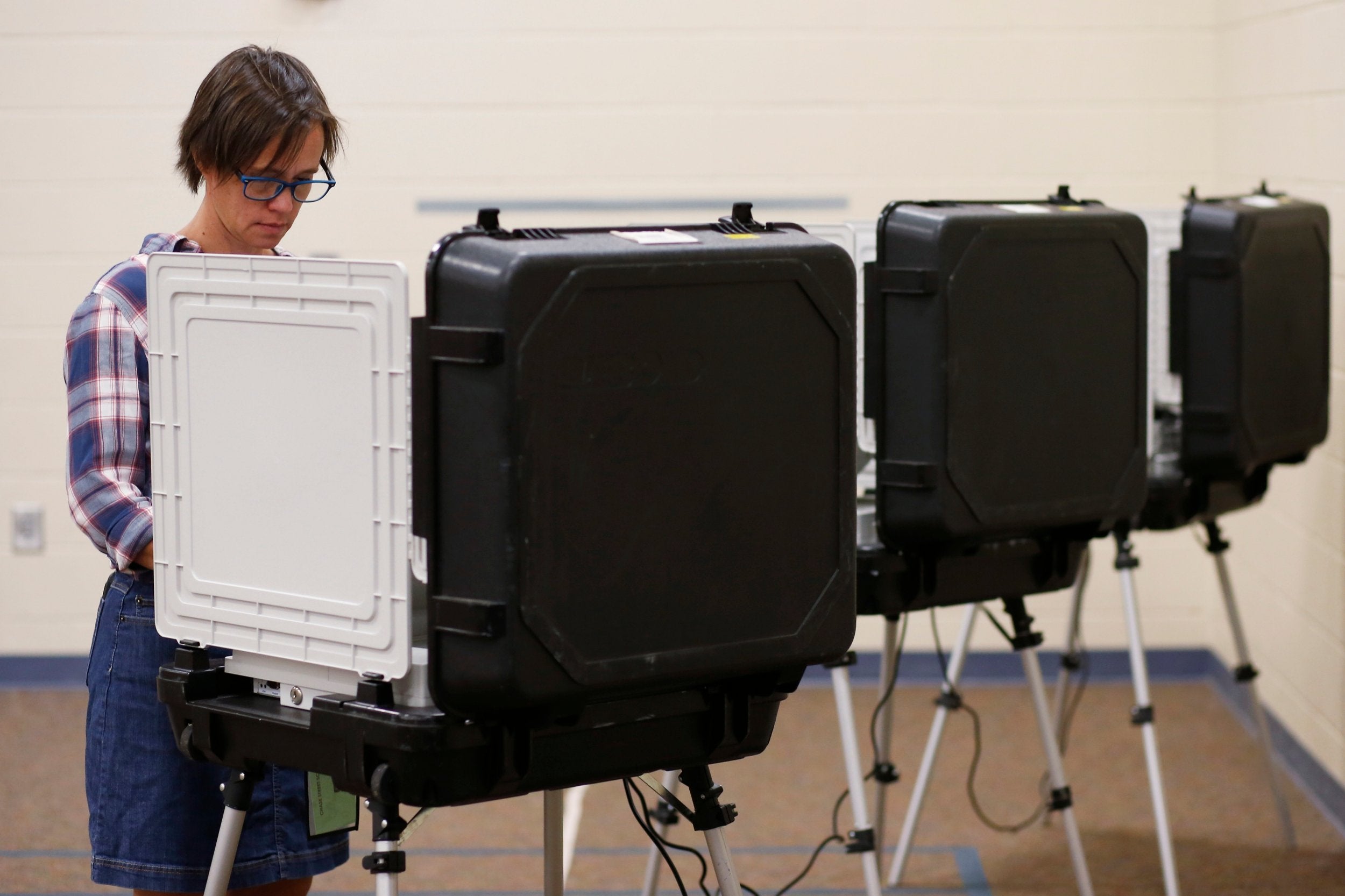 A voter casts their vote during an American primary election