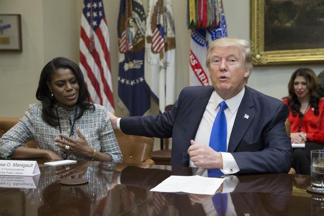 President Donald Trump holds an African American History Month listening session attended by Director of Communications for the Office of Public Liaison Omarosa Manigault (L) and other officials in the Roosevelt Room of the White House