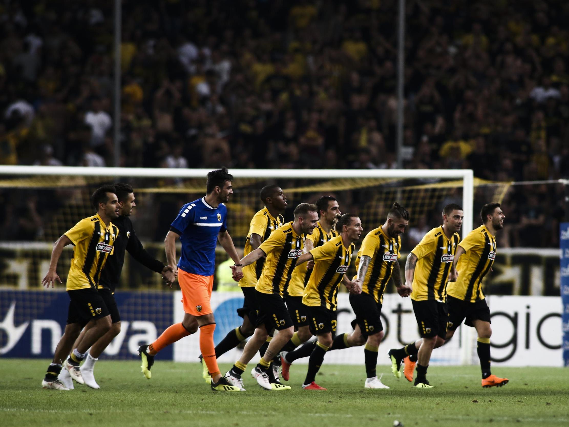 AEK Athens' players celebrate their victory