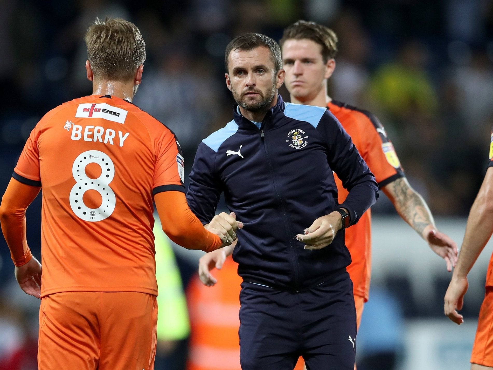 Luton Town manager Nathan Jones consoles his players after the Carabao Cup defeat by West Brom
