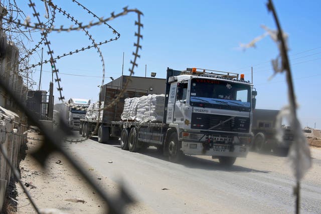 Trucks full of goods depart from the Palestinian side of the Kerem Shalom cargo crossing with Israel in Rafah, southern Gaza Strip, on Wednesday