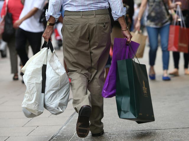 Shoppers carry bags in London