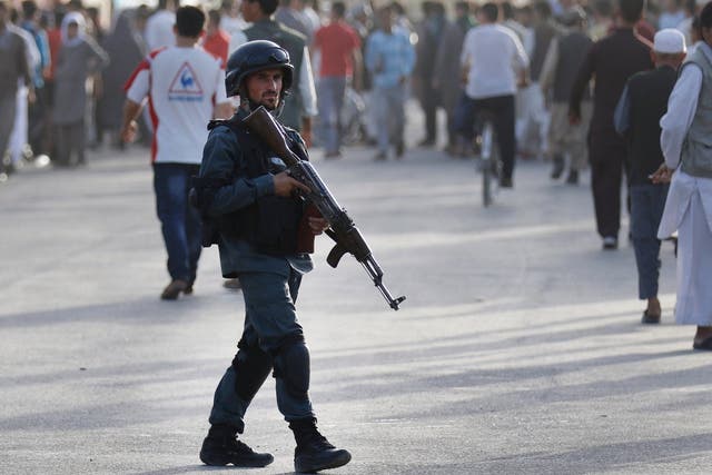 Afghan security patrols at the scene of a suicide attack in Kabul, Afghanistan