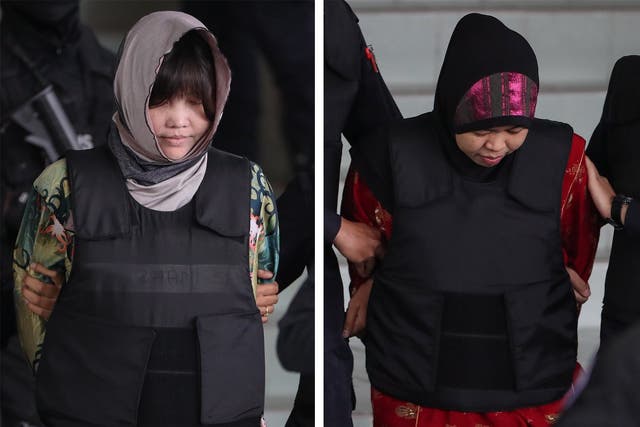 Suspects Doan Thi Huoang, left, and Siti Asiyah, right) are escorted out of the Shah Alam High Court in Malaysia