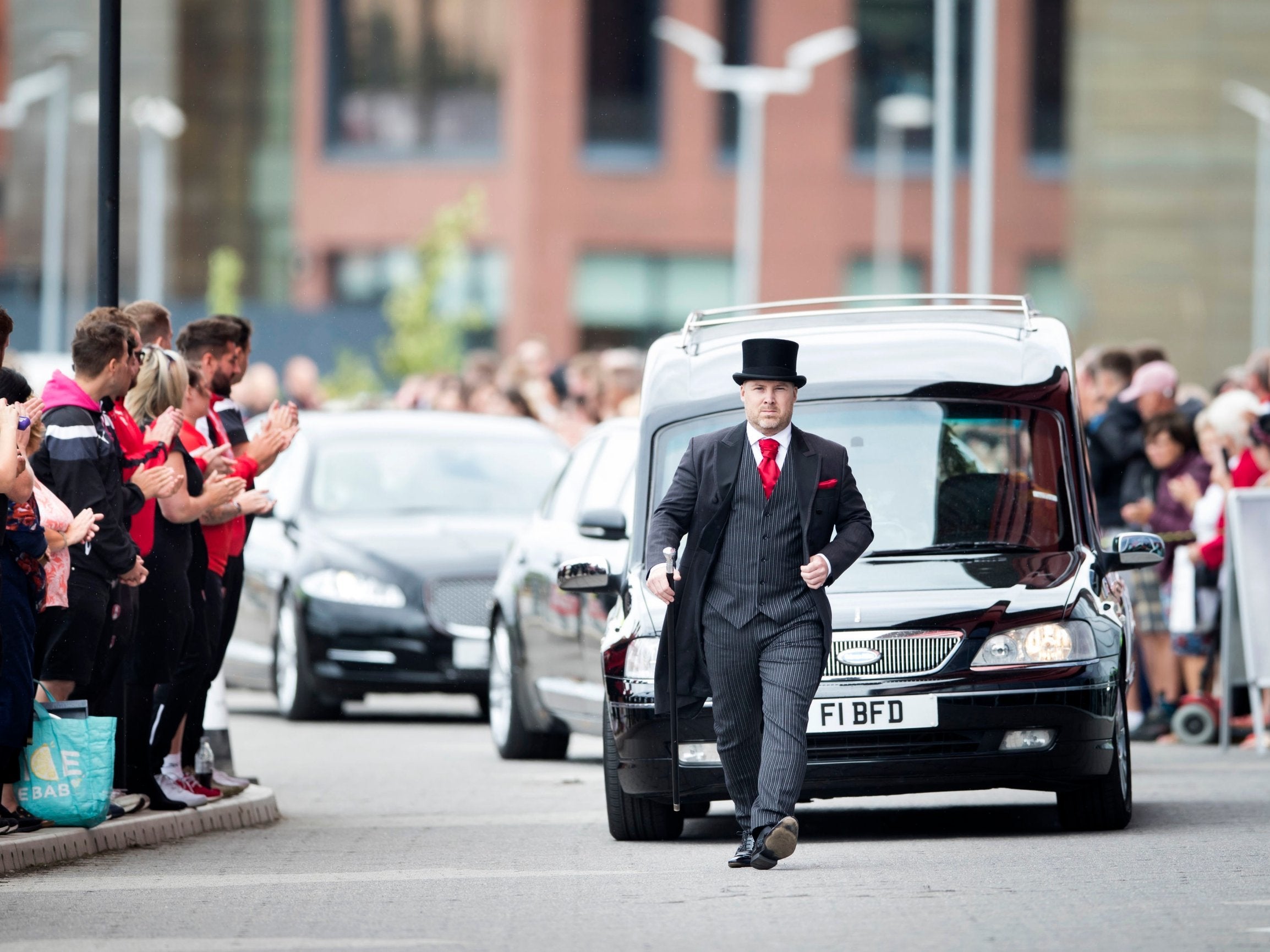 The cortege carrying the coffin of Barry Chuckle arrives at the New York Stadium