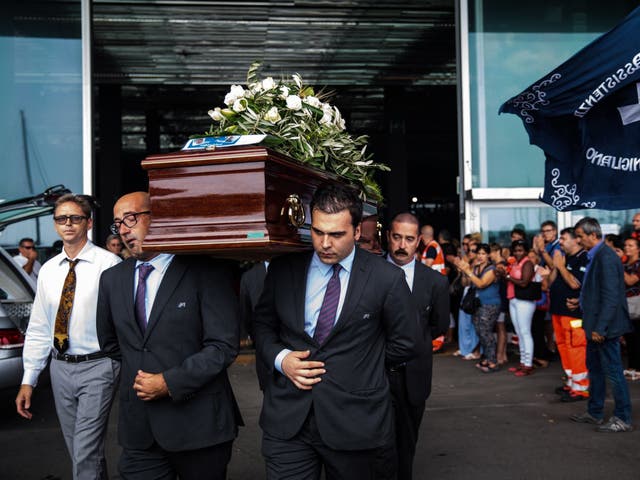 Coffins are carried out following a state funeral service for victims of the disaster