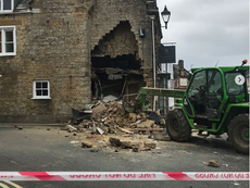 Woman’s lucky escape as cashpoint thieves wreck building with tractor
