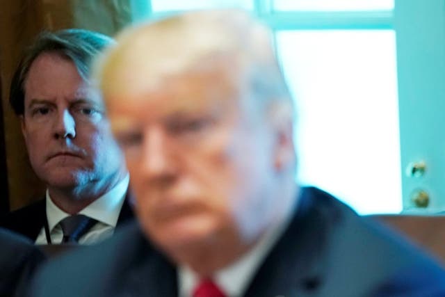 White House counsel Don McGahn listens behind Donald Trump during a cabinet meeting