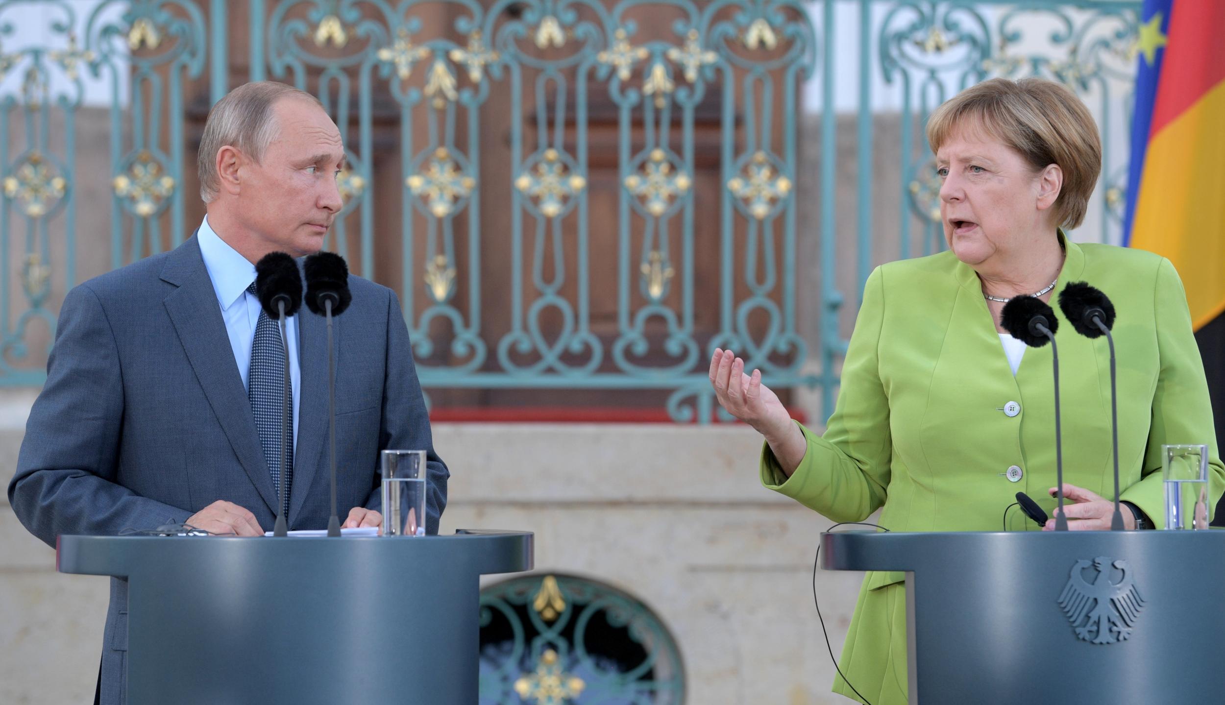 German chancellor Angela Merkel speaks next to Russian president Vladimir Putin at Meseberg Palace