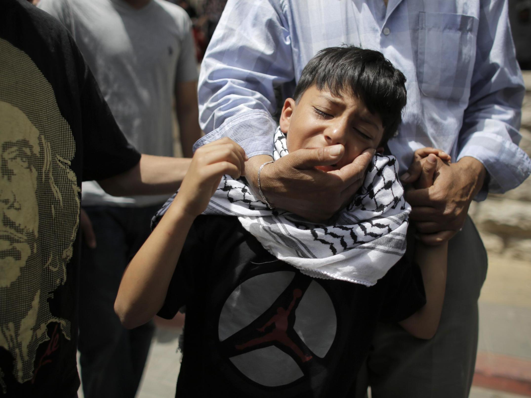 The brother of Nadim Nuwara cries at his funeral in Ramallah in May 2014