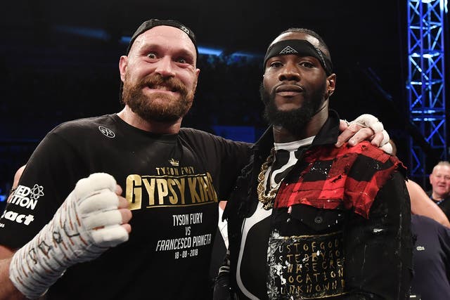Tyson Fury poses with rival boxer Deontay Wilder