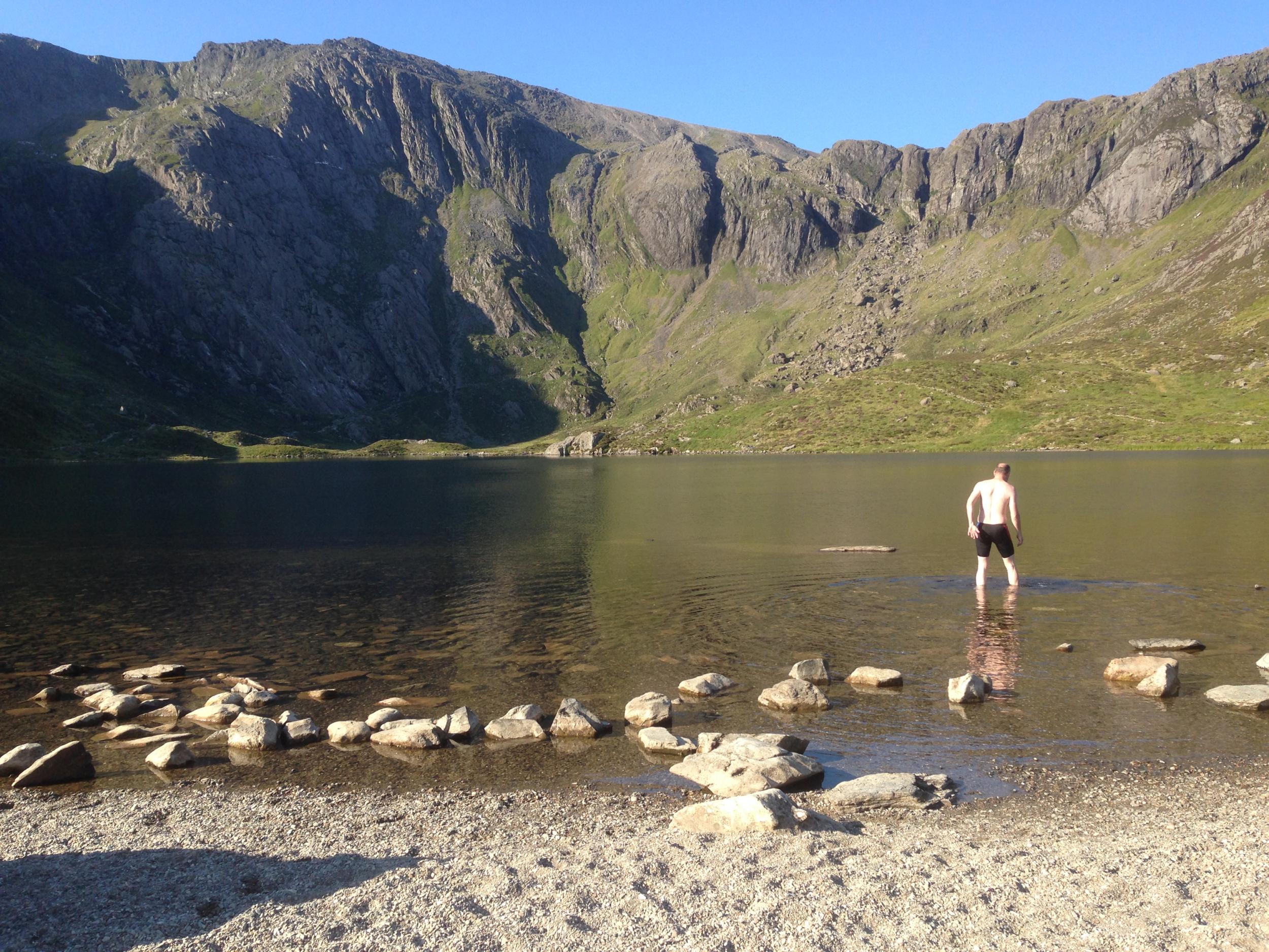 A swimmer walking into the River Wye