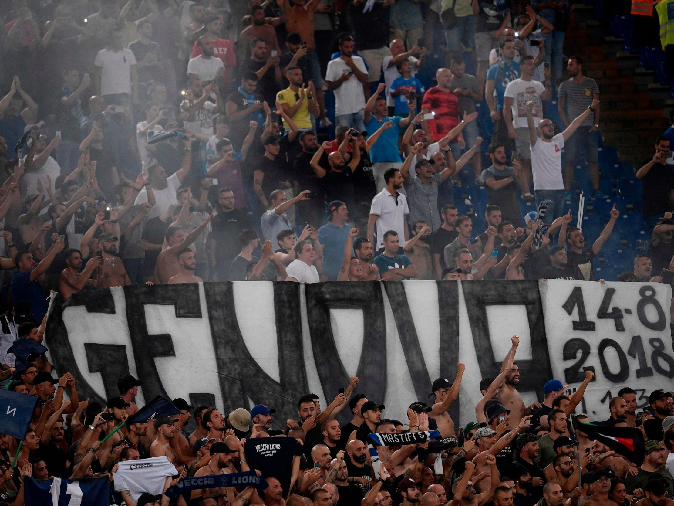 Napoli's fans hold a banner reading "Genova 14-8-2018" referring to Genoa's Morandi Bridge collapse