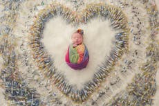Photo of newborn surrounded by IVF needles captures fertility struggle