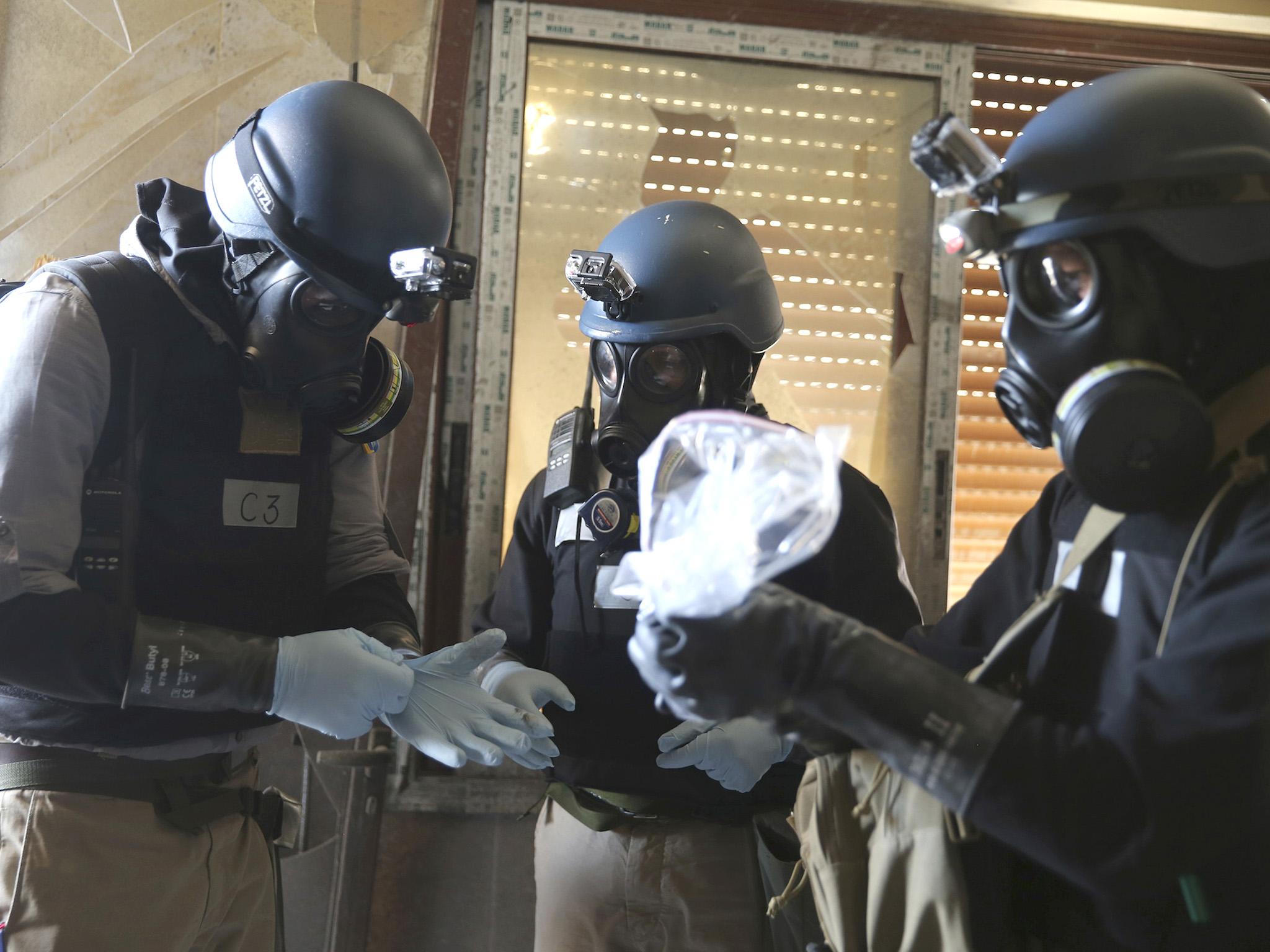 UN chemical weapons experts inspect the scene following a toxic gas attack in eastern Ghouta in August 2013