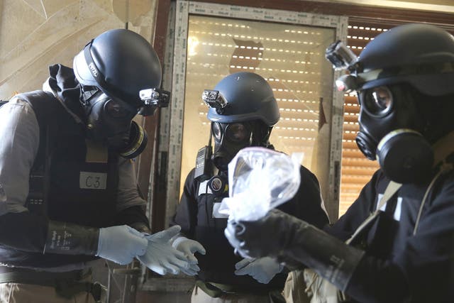 UN chemical weapons experts inspect the scene following a toxic gas attack in eastern Ghouta in August 2013