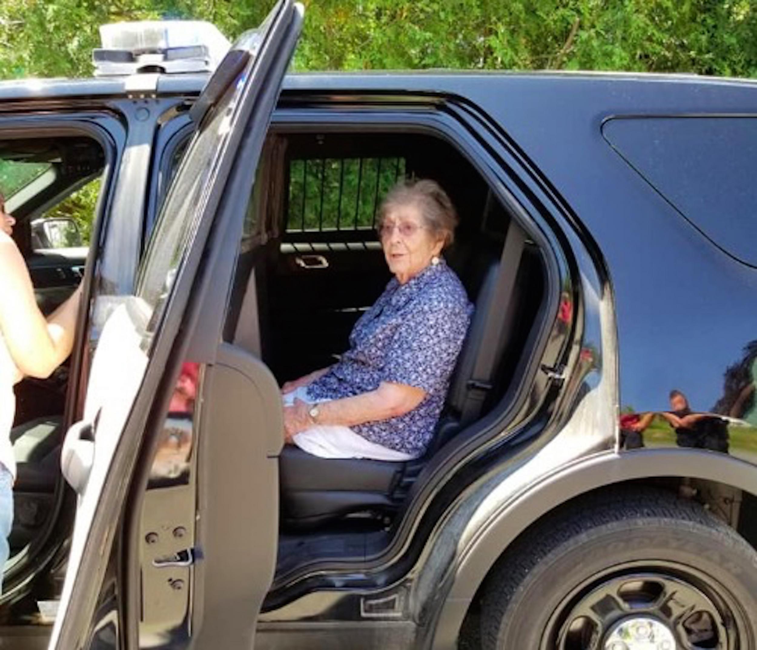 A 93-year-old woman in Maine is taken into a police car to experience a 'gentle arrest' on 9 July 2018