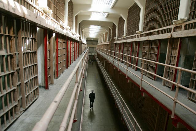 A National Park Service ranger walks down 'Broadway' in the main cell block on Alcatraz Island