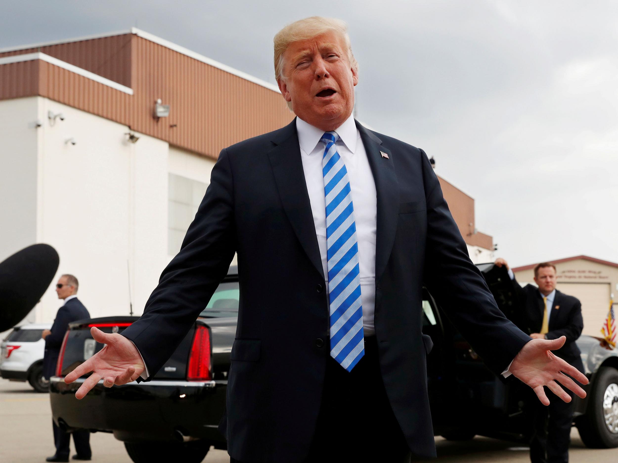 President Donald Trump speaks to the news media about the federal conviction of his former presidential campaign chairman Paul Manafort as he arrives for a campaign event in Charleston on 21 August 2018 (Leah Millis/Reuters)