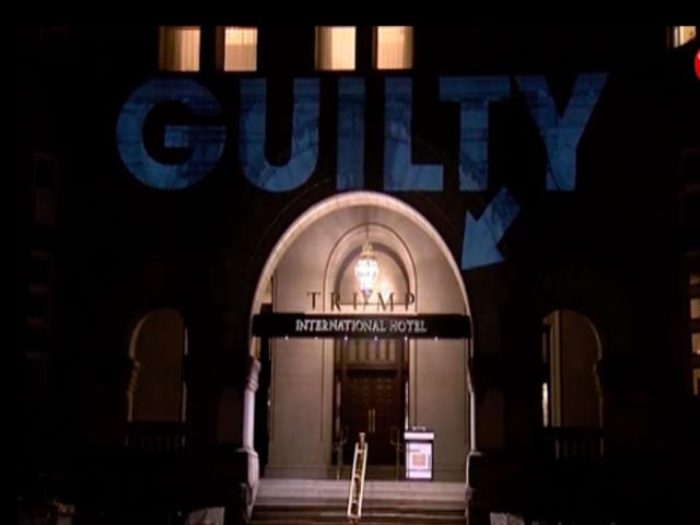 Word "Guilty" projected on Trump Hotel