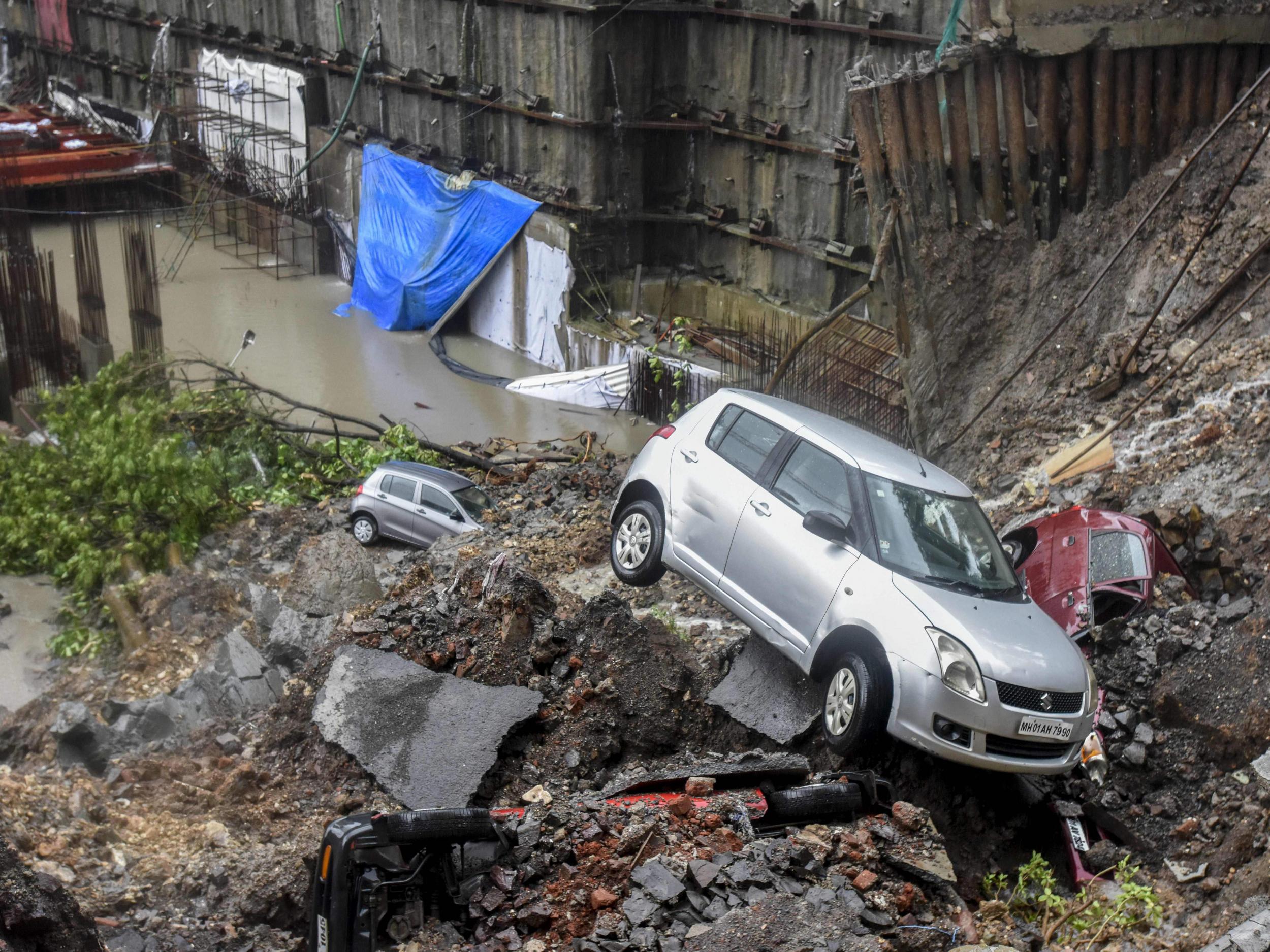 Damaged vehicles among debris after a landslide in Mumbai. India has been hit particularly hard by deadly landslides in recent years