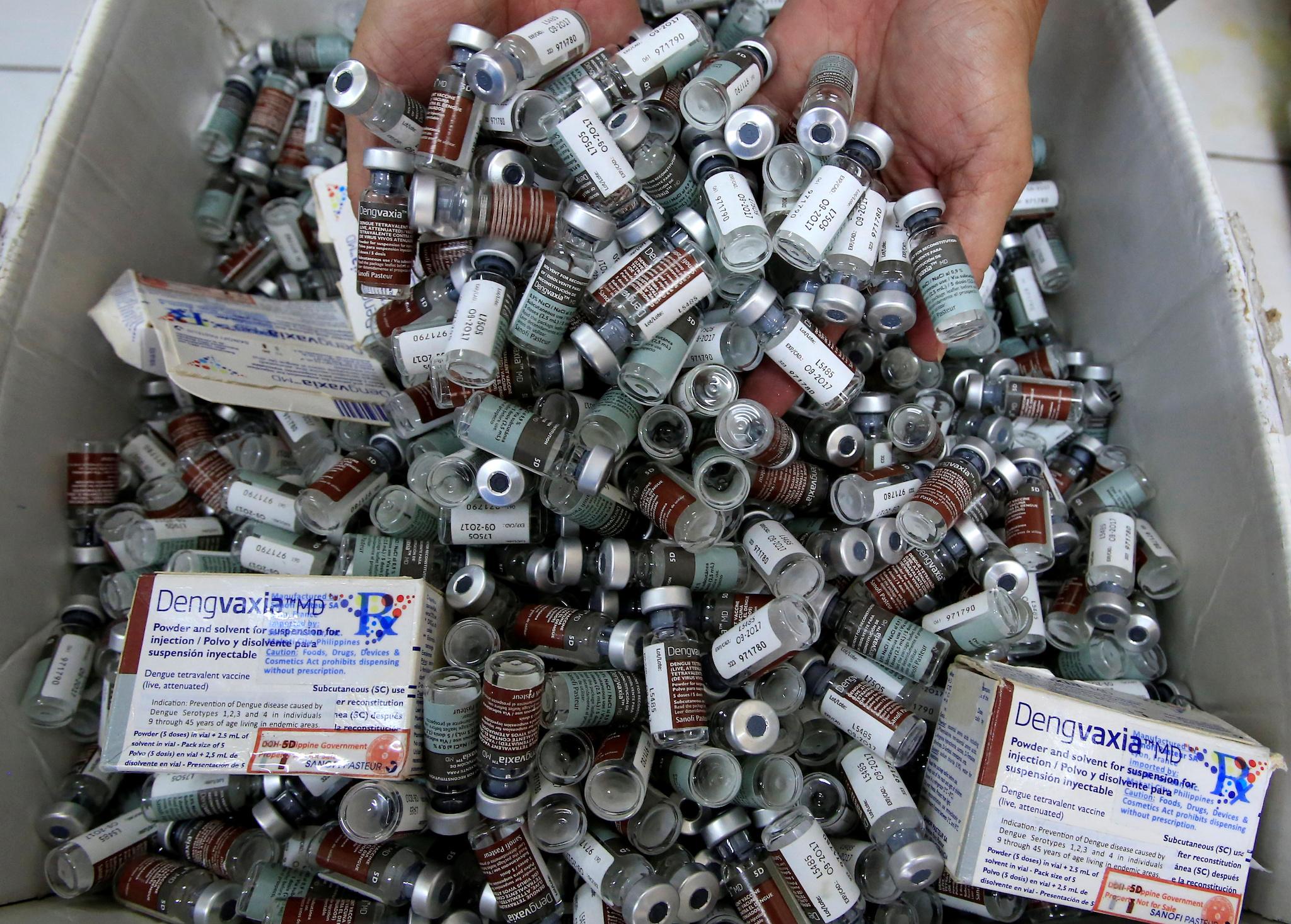 A worker shows used anti-dengue vaccine Dengvaxia inside a vaccine storage room in Sta. Cruz city, Metro Manila, Philippines December 4, 2017