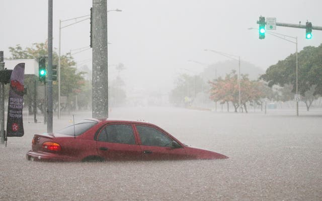 A car is submerged in floodwater as the archipelago is hammered by the storm