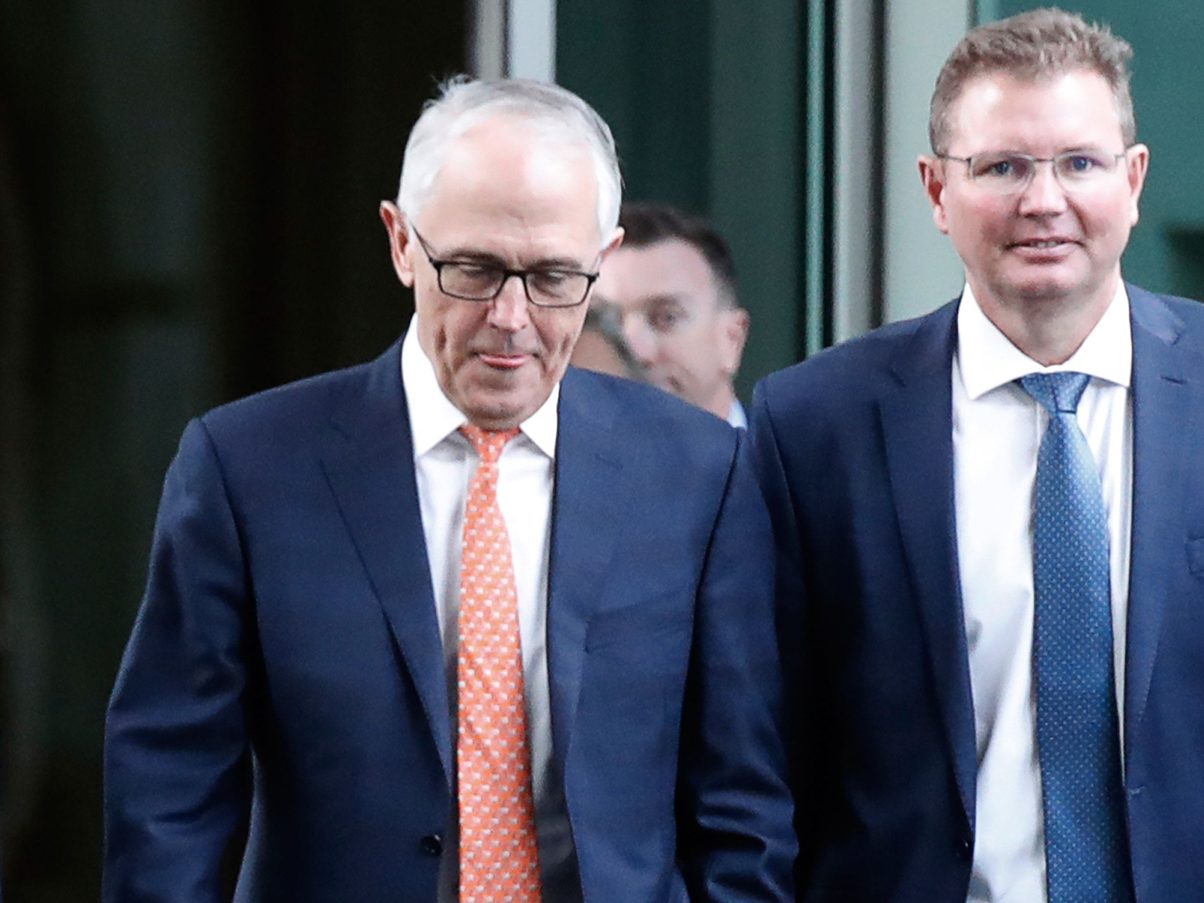 Australia's ousted Prime Minister Malcolm Turnbull (L) arrives for a party meeting in Canberra on 24 August, 2018