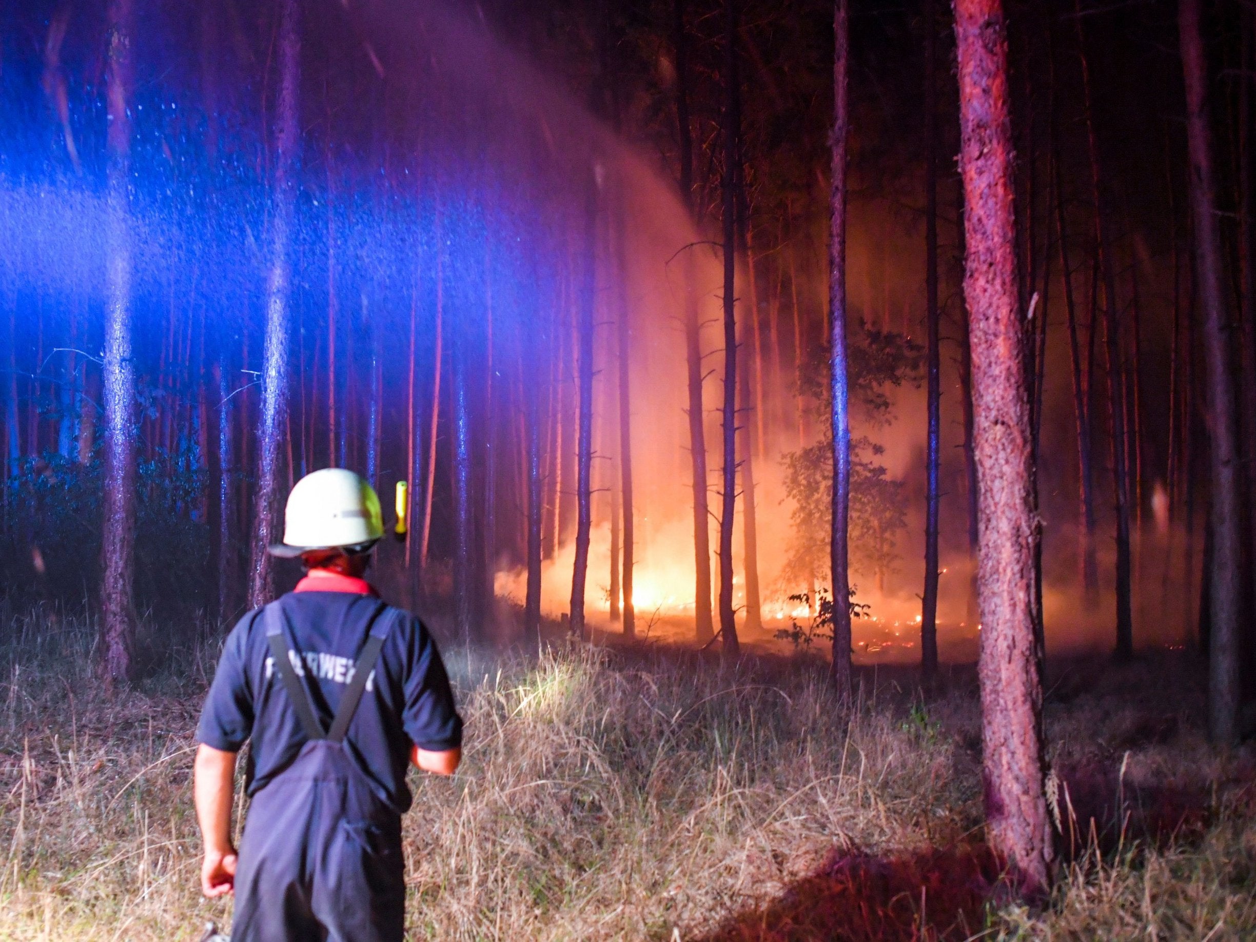 Firefighters battle a wildfire near the village Klausdorf, about 53 miles south of Berlin