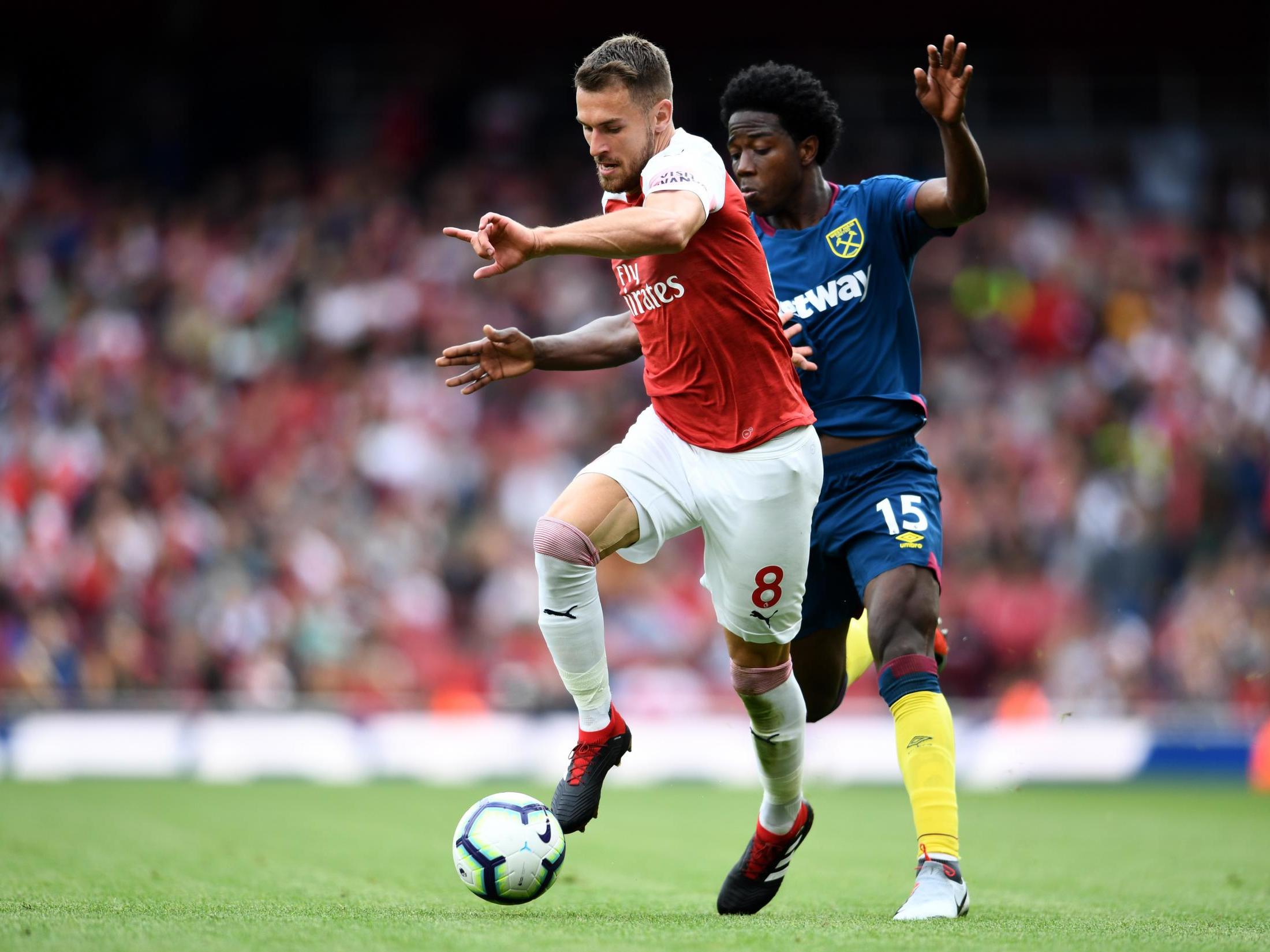 Aaron Ramsey attempts to get away from Carlos Sanchez