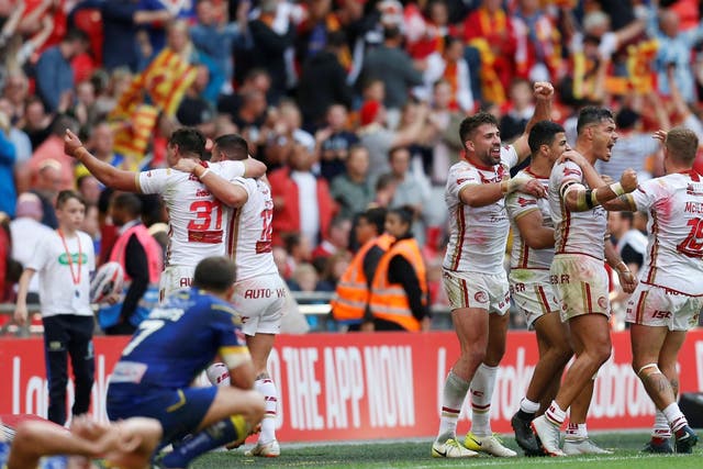The Catalans Dragons celebrate their victory after the final whistle