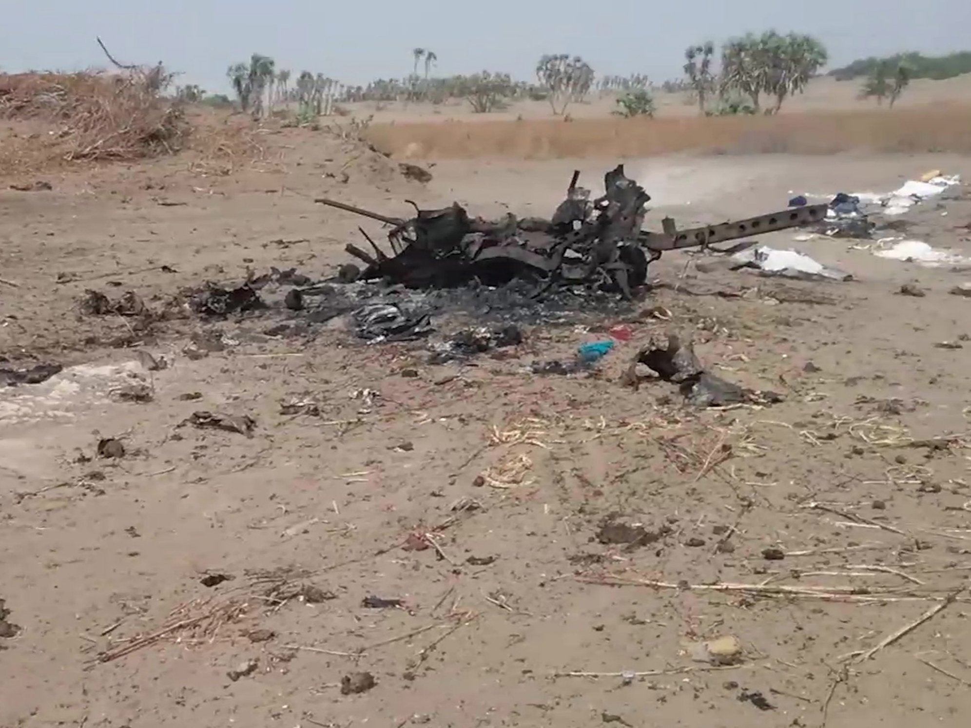 The wreck of a vehicle at the scene of an airstrike which allegedly hit a car carrying displaced people, killing women and children fleeing fighting in Al Durayhimi district