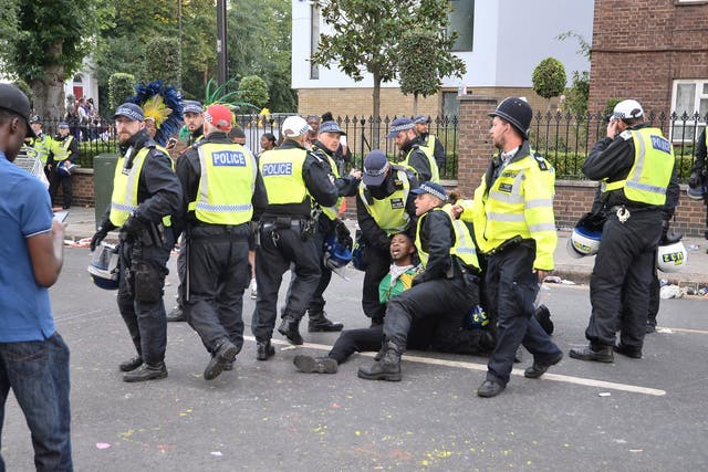 Police holding a man during Notting Hill Carnival in 2017