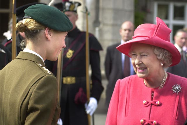 Queen Elizabeth II meets Capt. Philippa Tattersall, the first woman Army Commando on the lawn of Balmoral castle, Scotland.