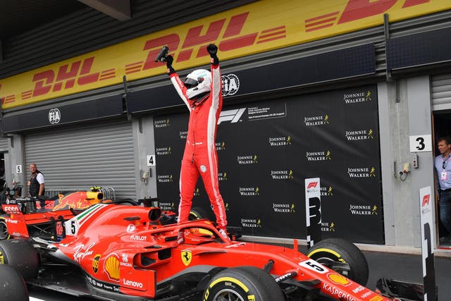 Sebastian Vettel celebrates in the pits after storming to victory