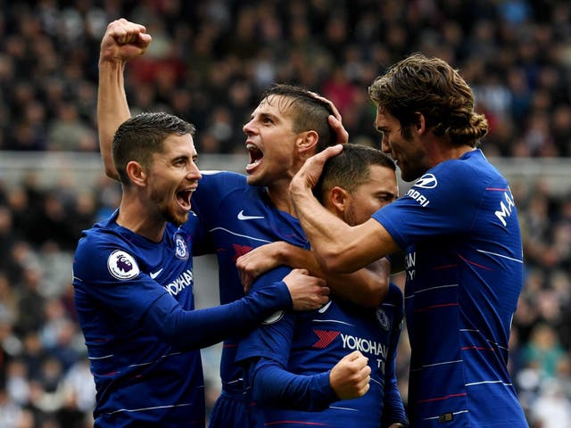 Eden Hazard of Chelsea celebrates with teammates after scoring a penalty