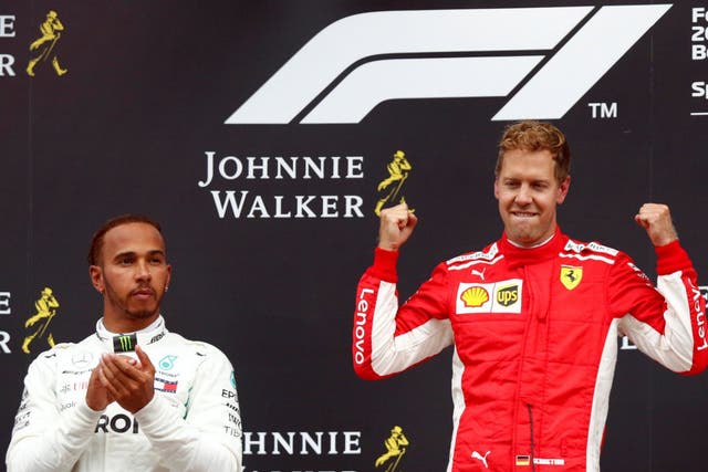Ferrari's Sebastian Vettel celebrates on the podium