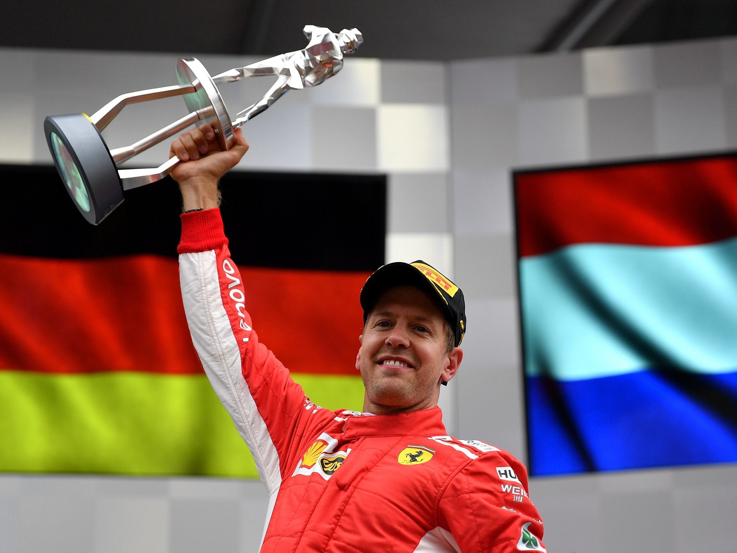 Race winner Sebastian Vettel of Ferrari celebrates on the podium