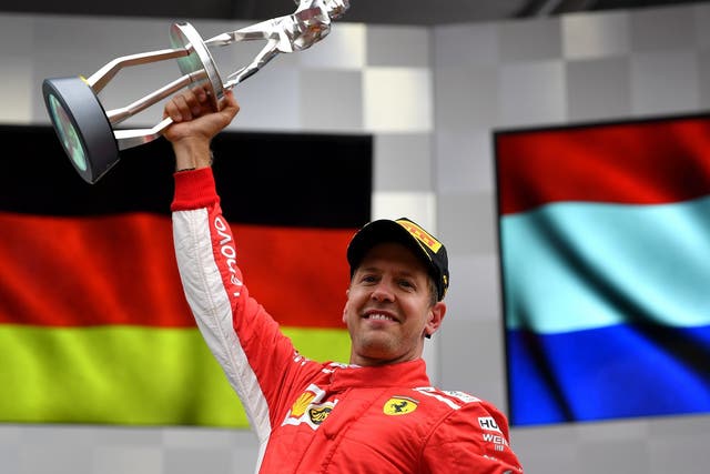 Race winner Sebastian Vettel of Ferrari celebrates on the podium
