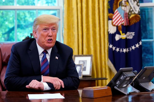 President Donald Trump speaks to Mexico's President Enrique Pena Nieto on the phone as he makes an announcement on the status of the North American Free Trade Agreement (NAFTA) from the Oval Office