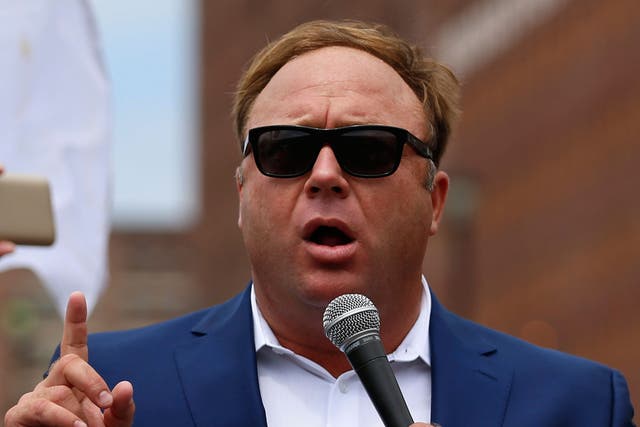 Alex Jones speaks during a rally in support of Donald Trump