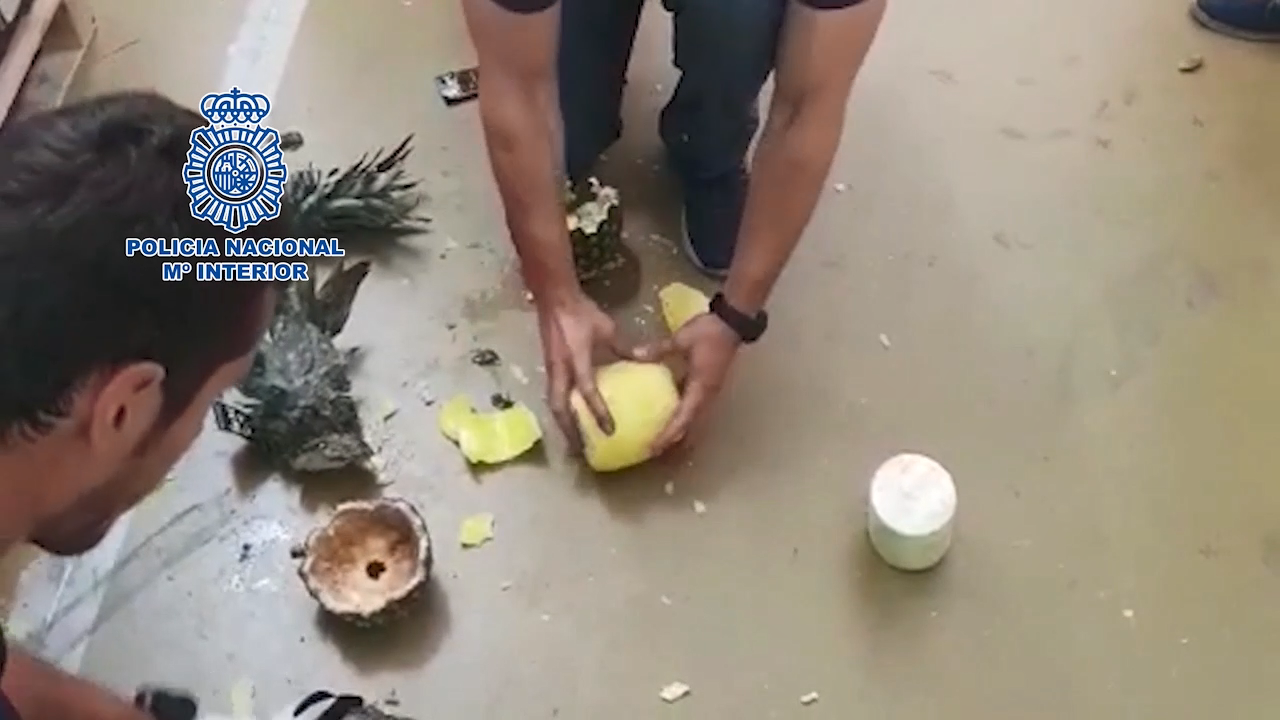 Police smash open pineapples containing cocaine at market in Madrid