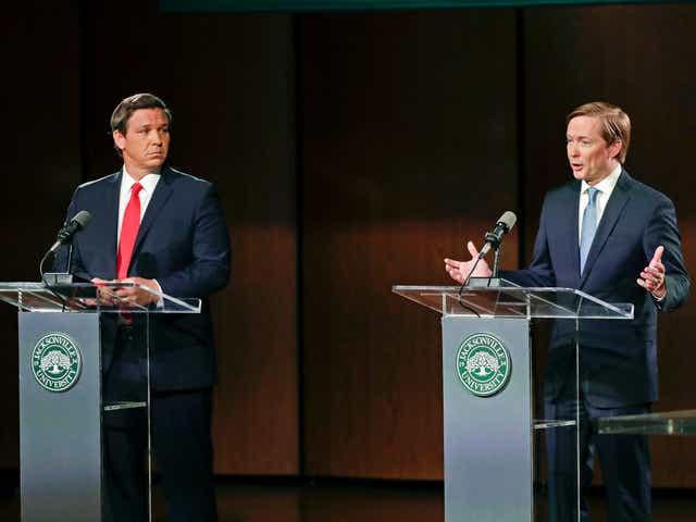 Republican gubernatorial candidate Ron DeSantis, left, listens to opponent Adam Putnam during a debate in Jacksonville