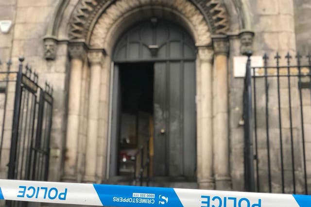 The charred front door of the Guru Nanak Gurdwara in Edinburgh