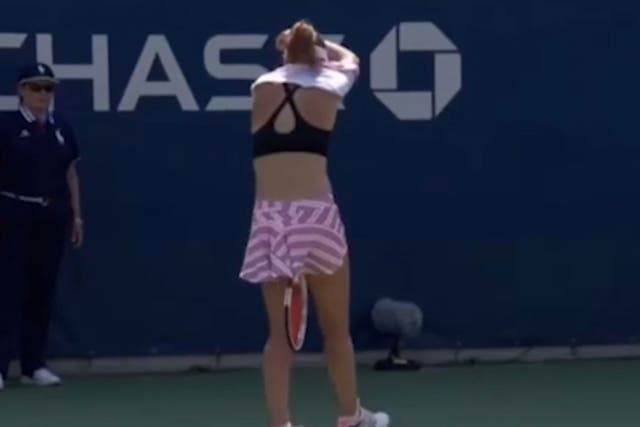 Cornet turned away from the cameras as she removed the top