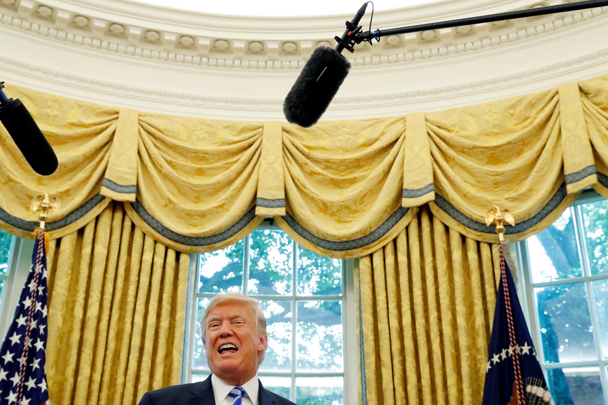 U.S. President Donald Trump answers questions from the news media after meeting with the President of FIFA Gianni Infantino in the Oval Office at the White House in Washington