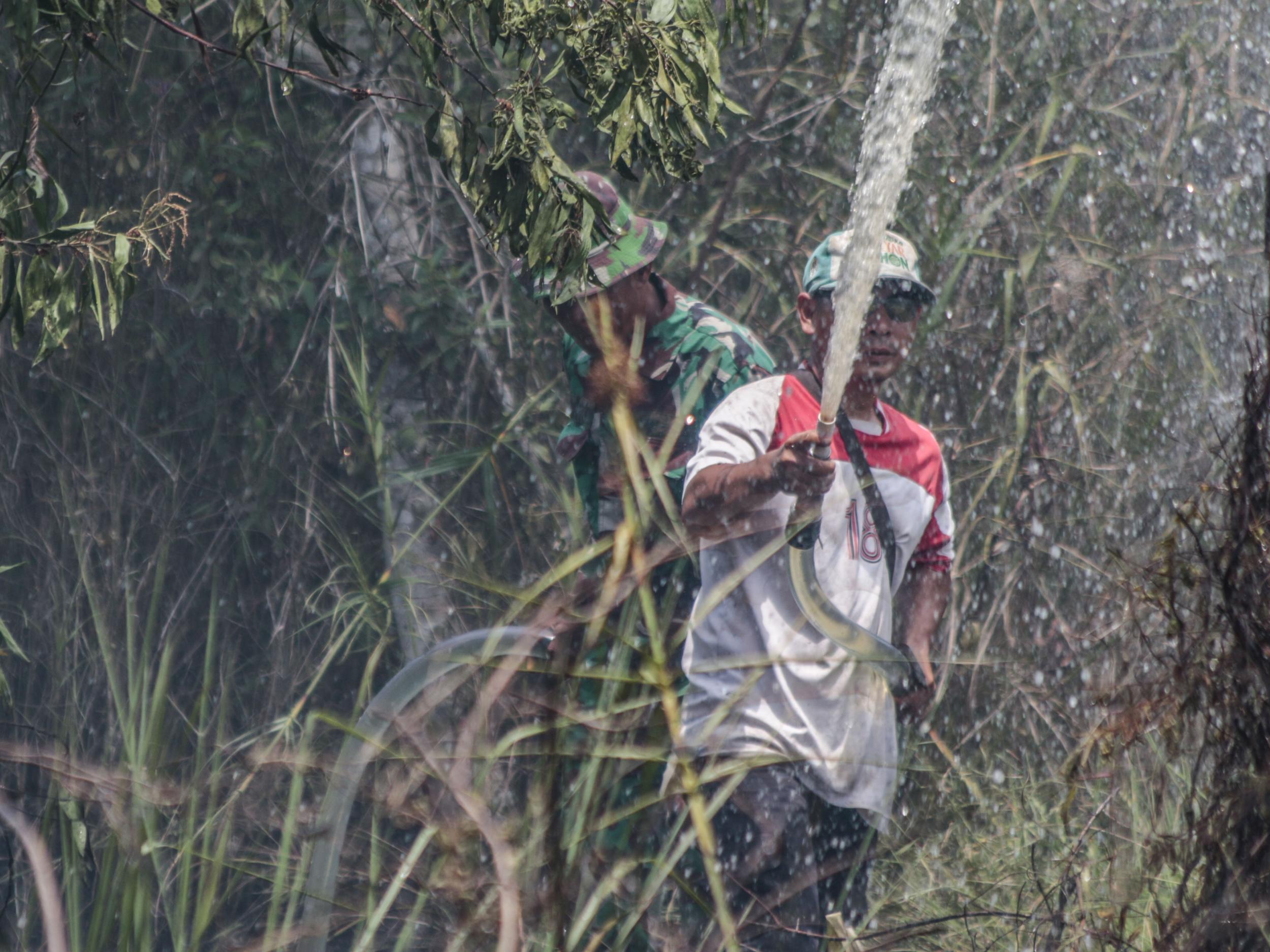 Firefighters battle the blaze in in Ketapang