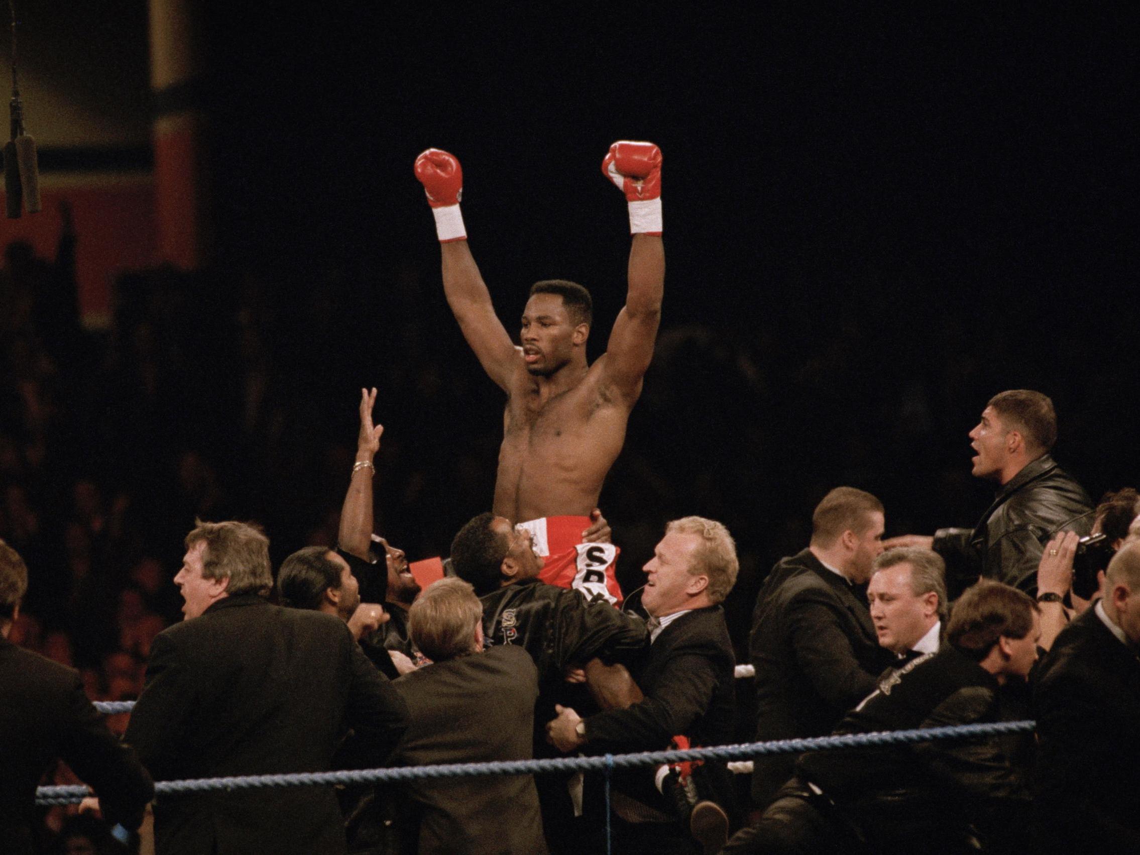 Lennox Lewis celebrates his WBC victory after a 2nd round knockout of Donovan Razor Ruddock on 31 October 1992