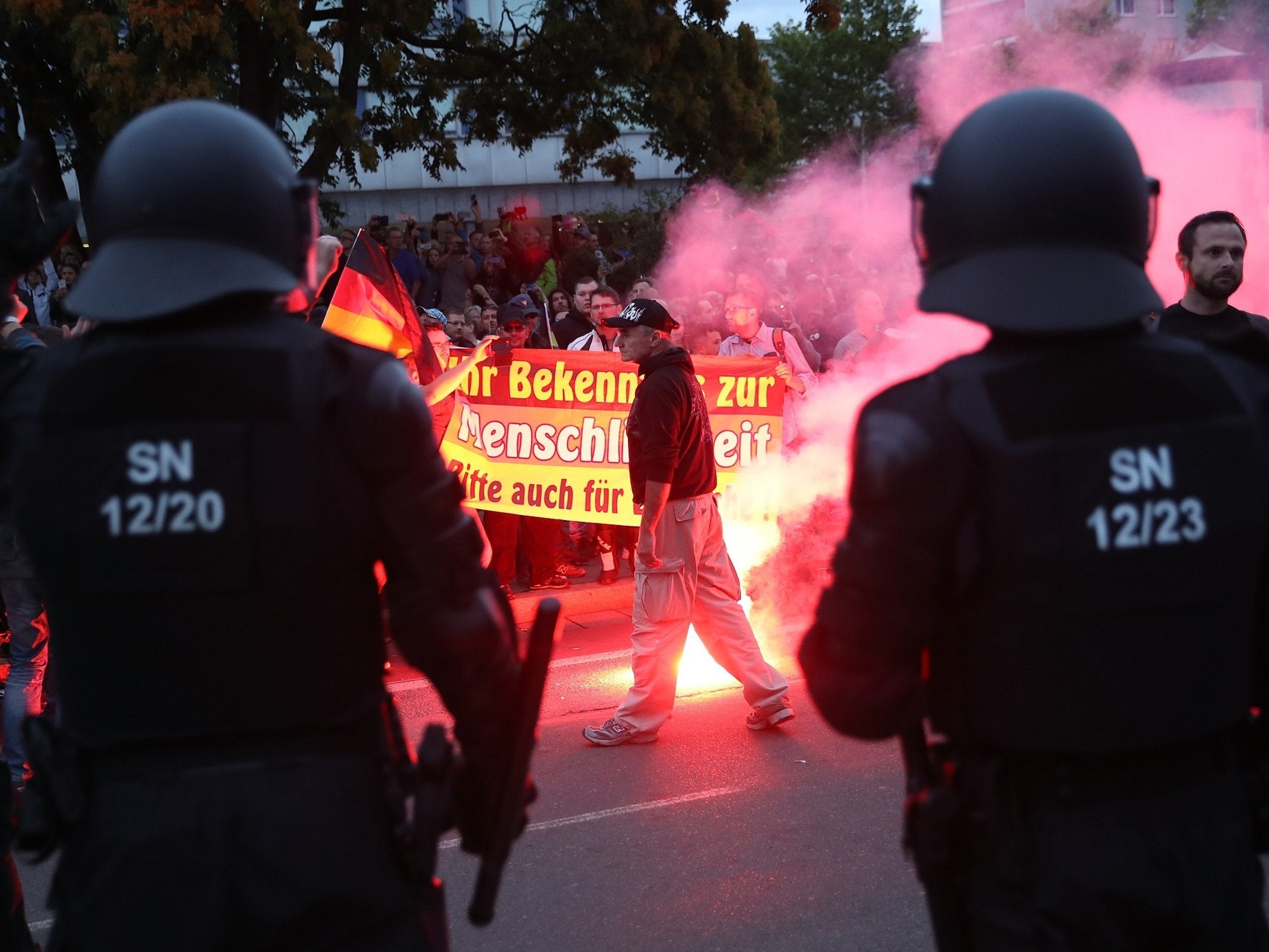 Riot police watch far-right demonstrators in Chemnitz on Monday