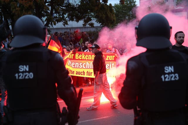 Riot police watch far-right demonstrators in Chemnitz on Monday